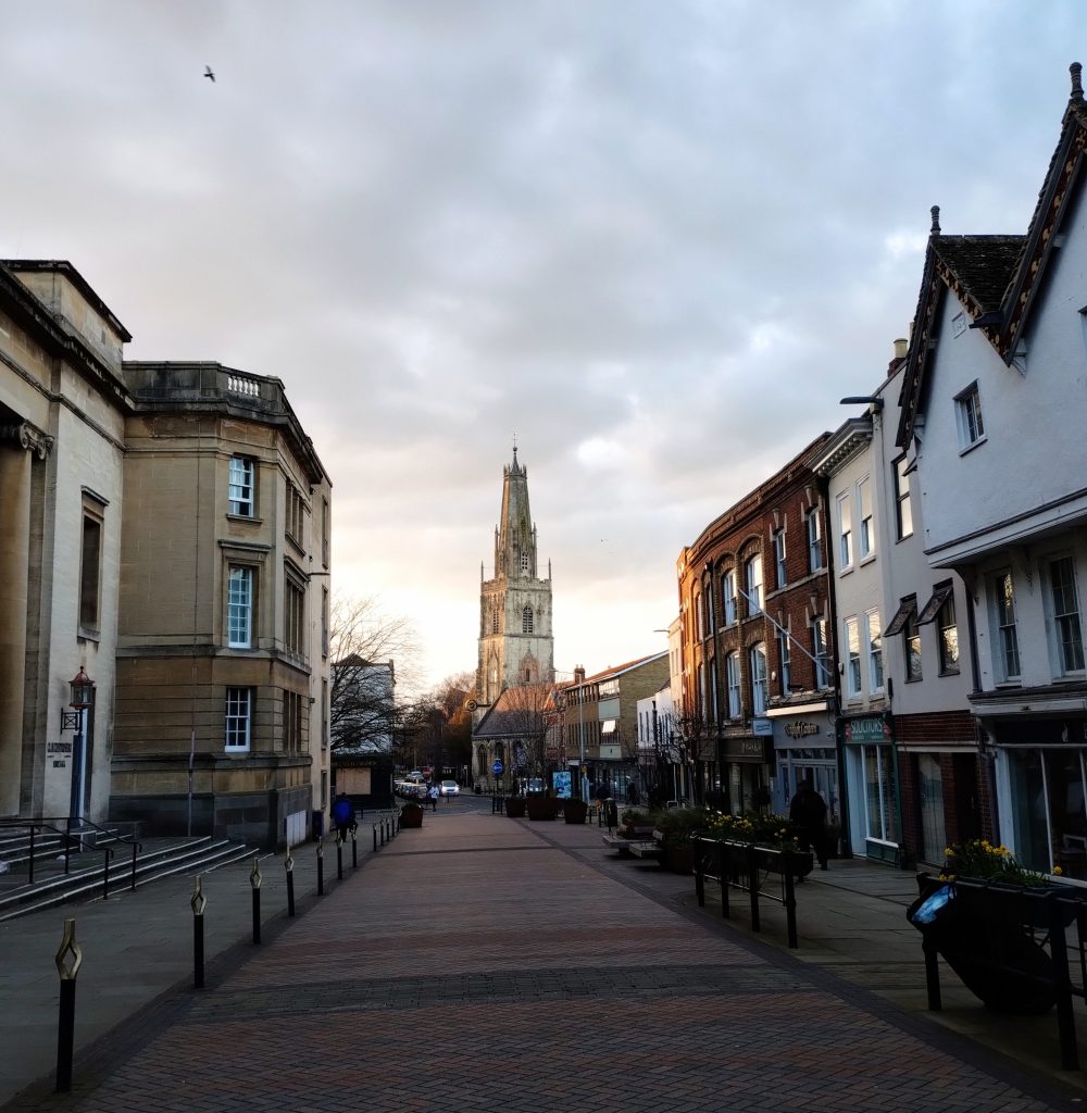 Photo: a church at the end of a street in Gloucester, with pretty end-of-day light.