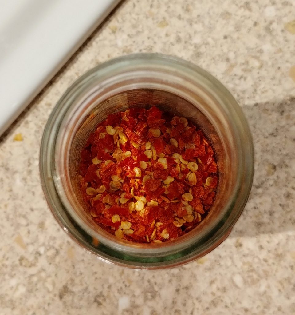 Photo: view down into a jar of finely chopped red chillies.