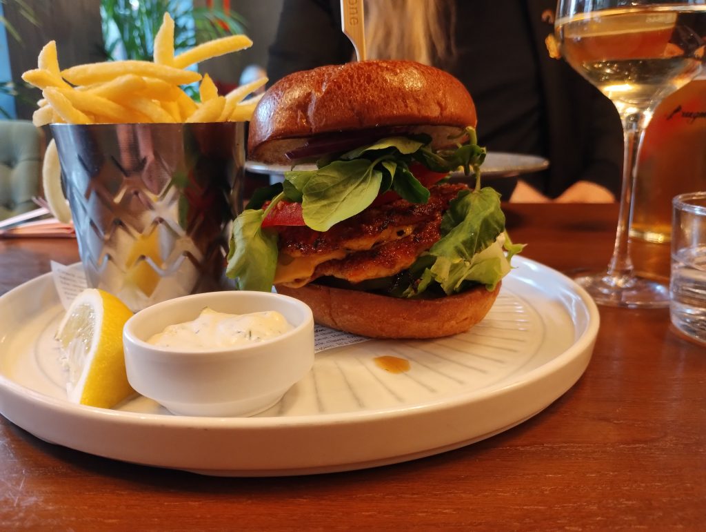 Little Joys: double lobster smash burgers in a bun with lots of salad and sauce, fries in a cup, slice of lemon, pot of ranch sauce.